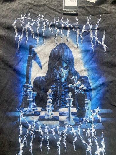 Criminal Damage Men's T-shirt Reaper Graphic Tee has a relaxed fit, short sleeves, a washed black look, and grim reaper graphics on the front.
