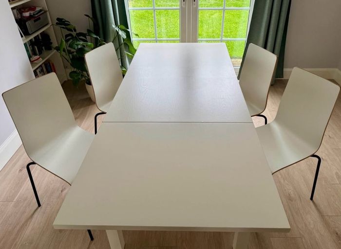 IKEA BJURSTA extendable dining table with 4 white dining chairs