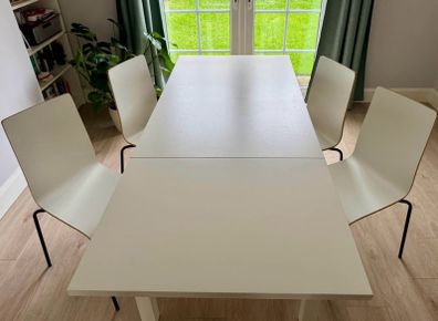 IKEA BJURSTA extendable dining table with 4 white dining chairs
