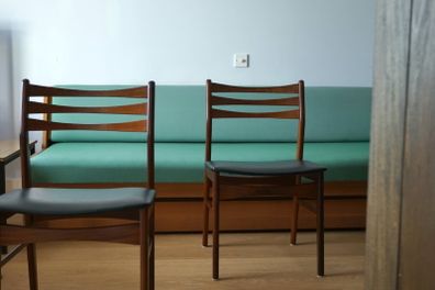 A pair of mid-century teak Danish dining chairs