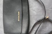 Michael Kors black crossbody bag with adjustable shoulder strap and gold-tone hardware. In great condition, only some colour fading on the logo, as shown in the photos.