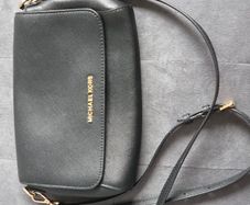 Michael Kors black crossbody bag with adjustable shoulder strap and gold-tone hardware. In great condition, only some colour fading on the logo, as shown in the photos.