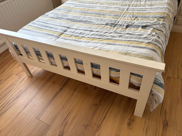 Cream wooden double bed
