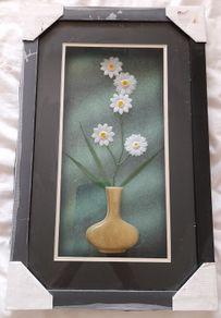 Framed arrangement of plastic flowers