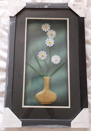 Framed arrangement of plastic flowers