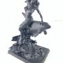 Girl sitting on a dolphin figurine Image 4