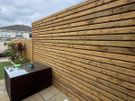 Custom timber garden fencing with integrated planters and bench Image 5