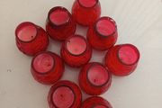 10 candles in red glass holders