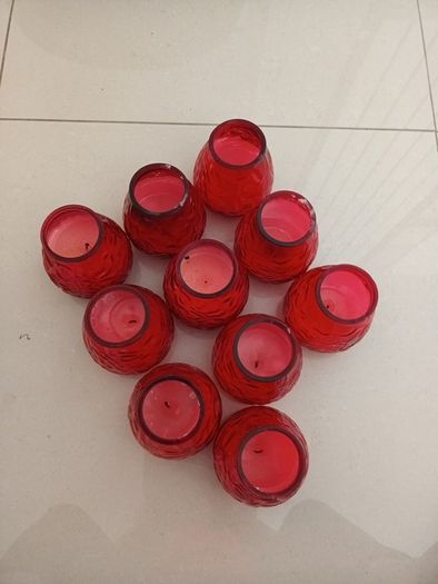 10 candles in red glass holders