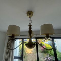 Two antique brass chandeliers - cream shades.