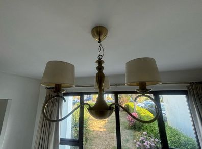 Two antique brass chandeliers - cream shades.