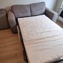 Grey two-seater sofa bed with matching storage footstool Image 7