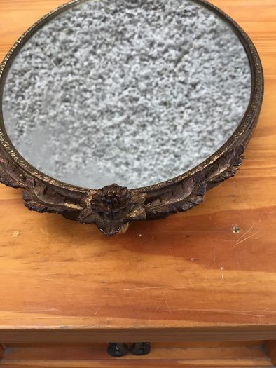Brass framed ornate oval mirror