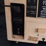 Ideal Prop, Vintage Working Boots Audio TV12 Portable Black and White CRT Television, featuring a cream plastic casing with side control dials and a 12 inch screen. Designed with dual power capabilities supporting standard mains voltage (240V) as well as  Image 9