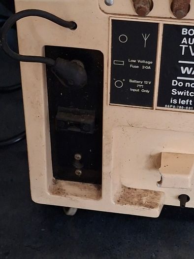 Ideal Prop, Vintage Working Boots Audio TV12 Portable Black and White CRT Television, featuring a cream plastic casing with side control dials and a 12 inch screen. Designed with dual power capabilities supporting standard mains voltage (240V) as well as 