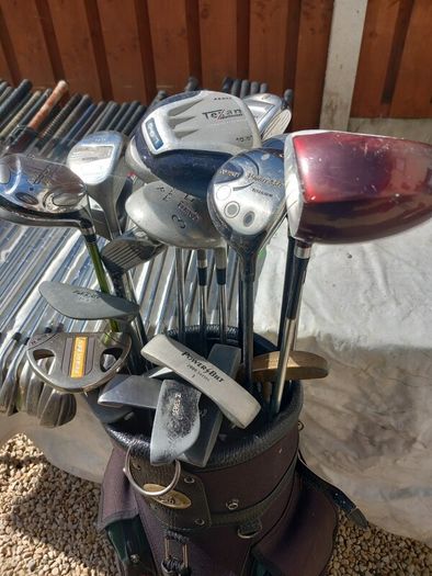 A selection of Golf clubs. Bags and golf balls.