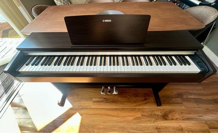 Yamaha Arius YDP-142 Digital Piano with rosewood finish and matching stool