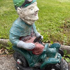 Vintage Reconstuted stone garden gnome on car, hand painted