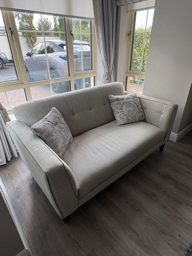 Modern two-seater sofa in light grey fabric