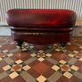 Leather Footstool on brass Castors. Image 2