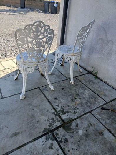 2 cast iron chairs
