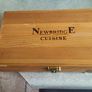 A Newbridge Cuisine set of six steak knives with serrated blades and wooden handles. Image 5