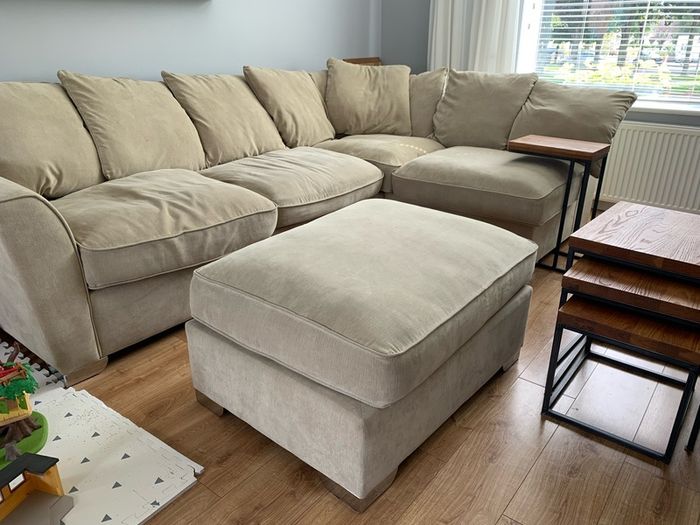 Corner sofa with footstool