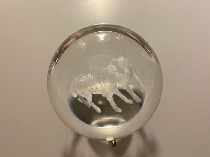 Beautiful glass ball with hologram  of  wolfs inside it