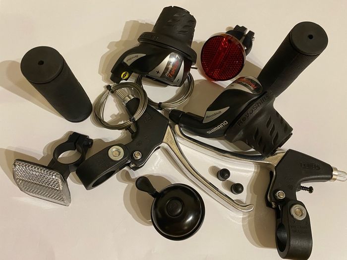 New Shimano Gear Shifters RevoShift SL-RS36-7-LN Twist Grip Shifter for 3 x 7 Speed Mountain bike Includes Gear Cables, Set Black Grips, Aluminium Brake lever, Set Light Reflector, Set Valve Caps and Flick-bell.
