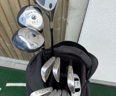 Older set of golf clubs with bag